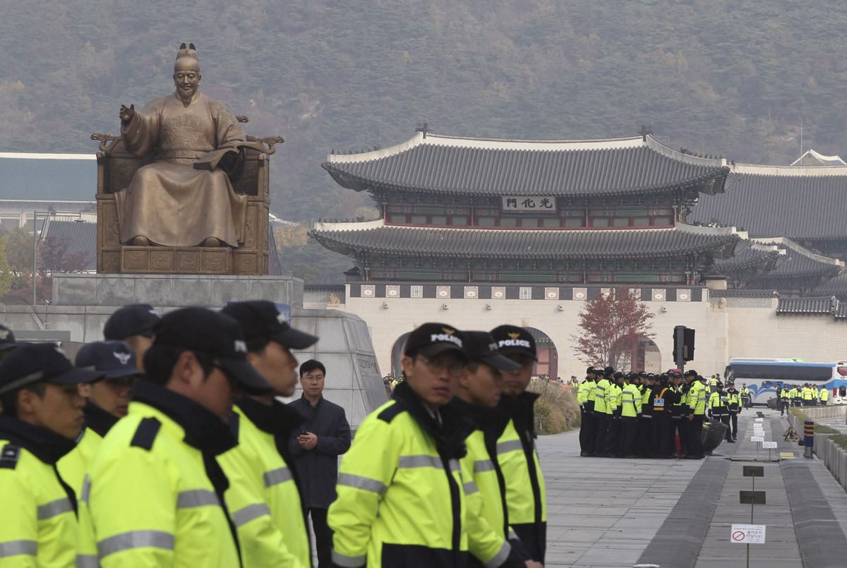 South Korean police officers stand guard Monday near the Japanese Embassy in the event of illegal protests against Japanese Prime Minister Shinzo Abe's visit in Seoul, South Korea.
