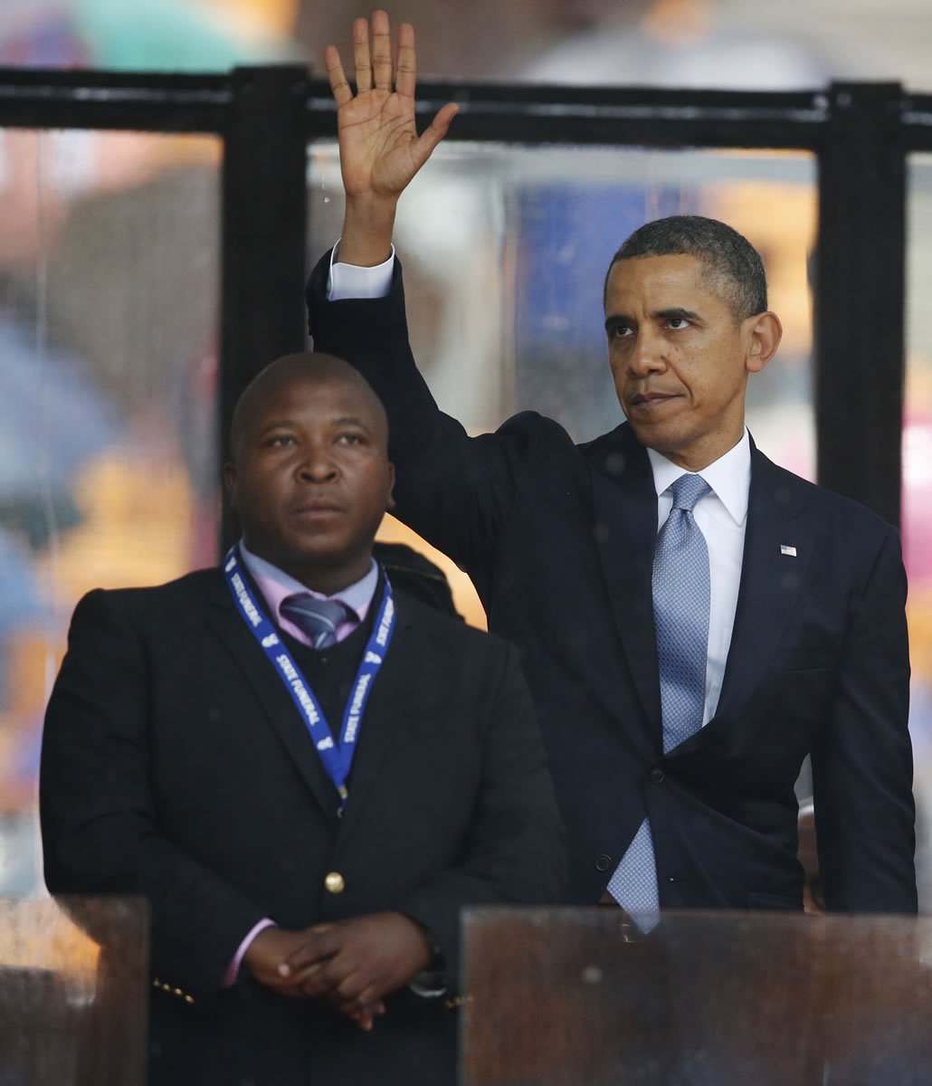 President Barack Obama waves standing next to the sign language interpreter after making his speech Tuesday.