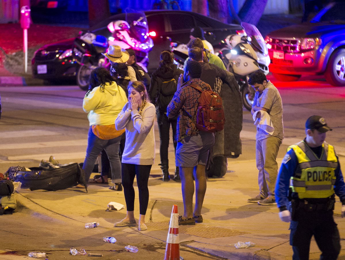 Bystanders react after several people were struck by a vehicle on Red River Street in downtown Austin, Texas, at SXSW on Wednesday.