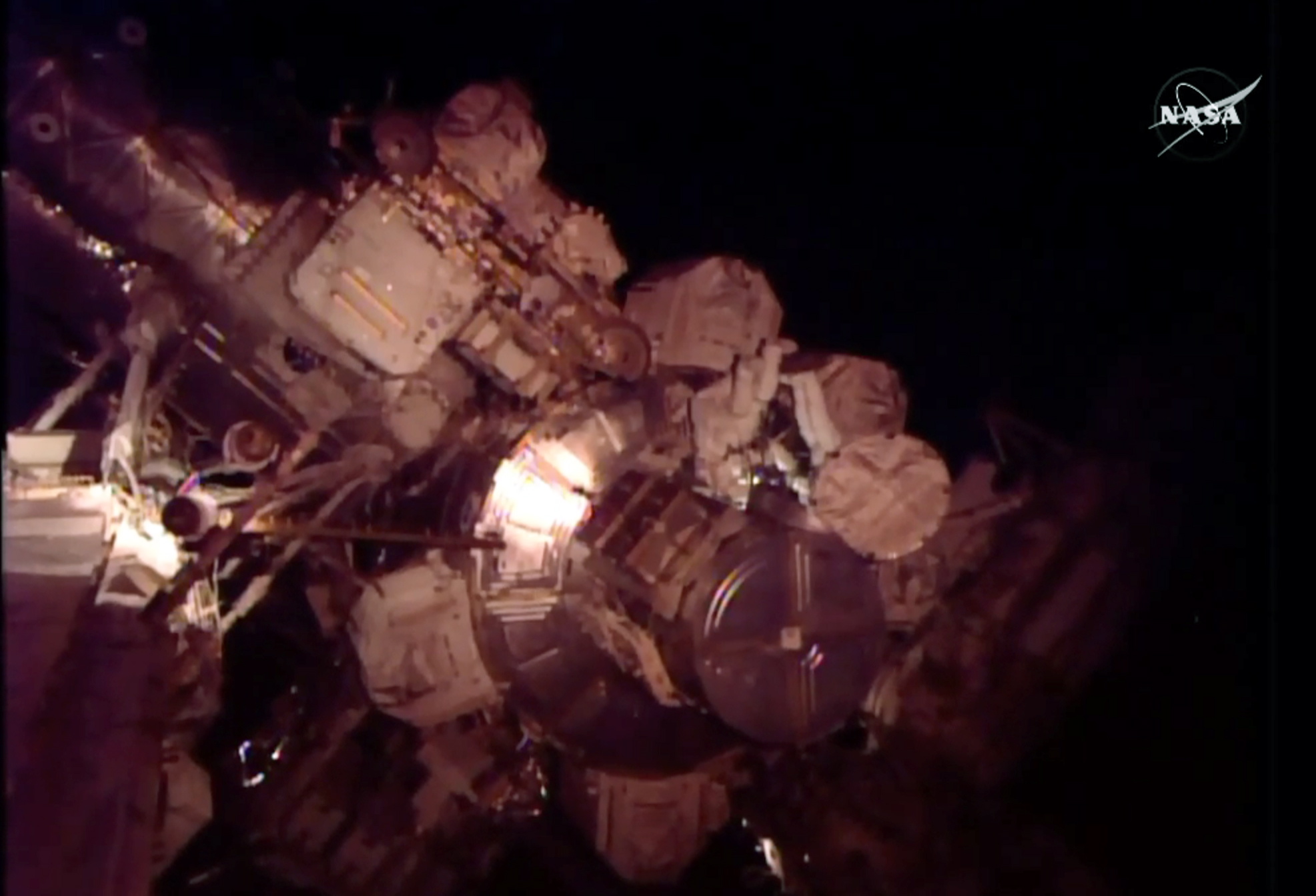 In this frame grab from NASA Television, astronauts Scott Kelly and Kjell Lindgren perform maintenance outside the International Space Station on Friday. Friday&#039;s excursion involves work on the space station&#039;s cooling system. Kelly has been at the 250-mile-high outpost since March, and isn&#039;t due back until next March. Friday marks his 224th day in orbit, a U.S. record.