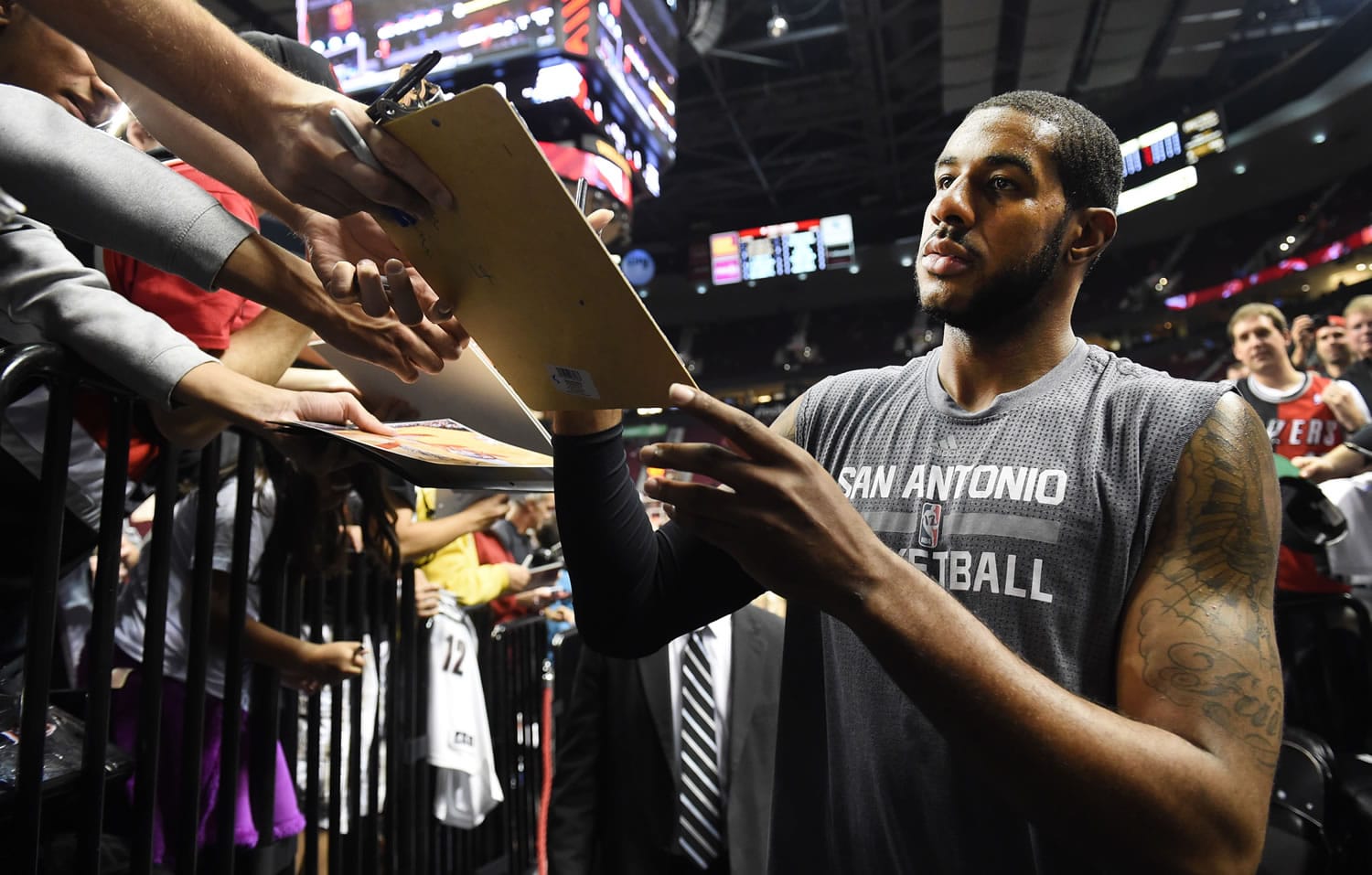 San Antonio Spurs forward LaMarcus Aldridge signs autographs before an NBA basketball game against the Portland Trail Blazers in Portland, Ore., Wednesday, Nov. 11, 2015.