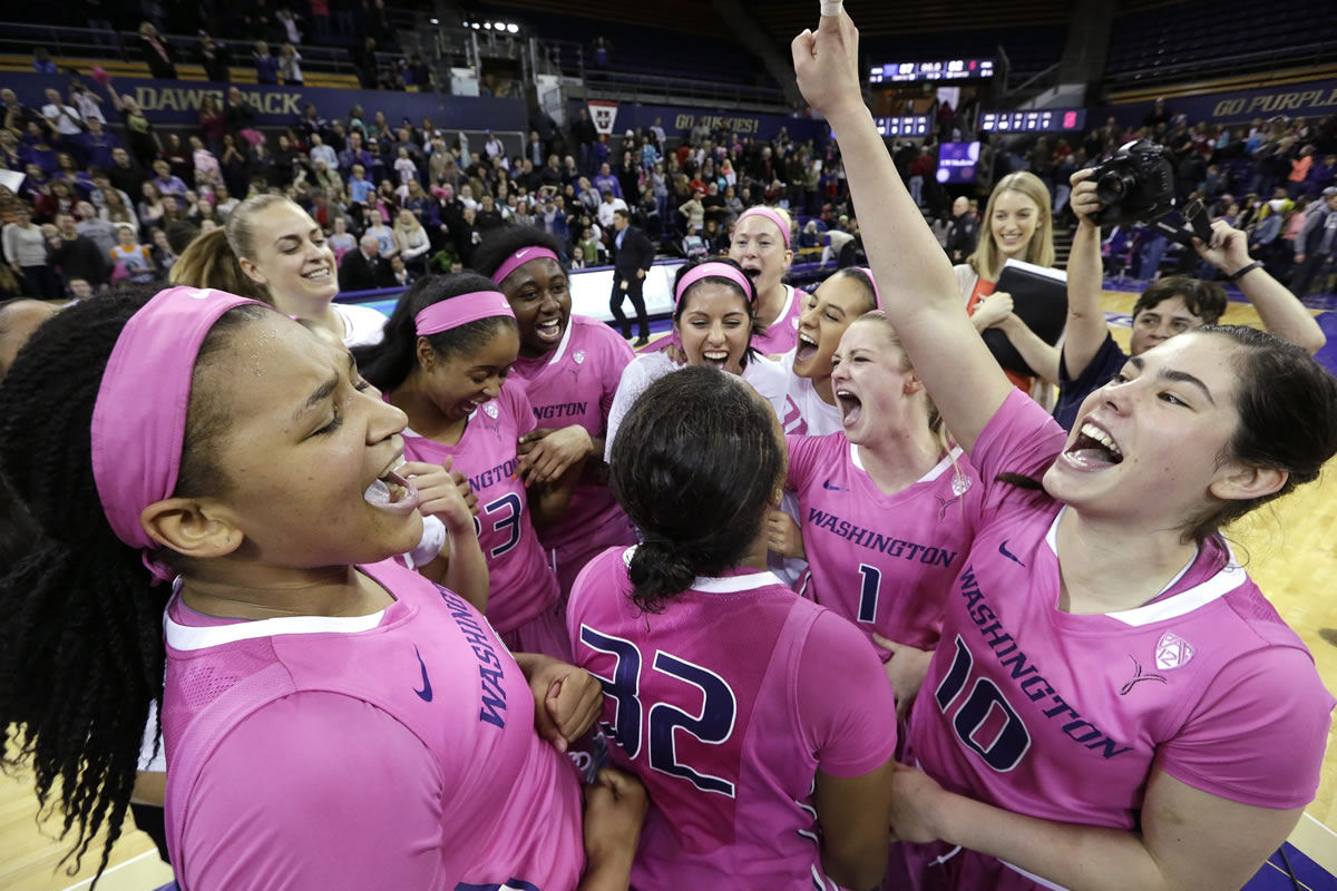Washington's Talia Walton, left, and Kelsey Plum, right, celebrate with teammates after they upset No. 3 Stanford on Sunday.