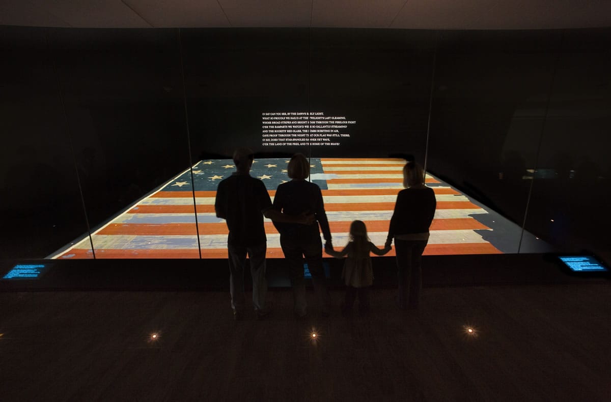 A family views the flag that inspired the song &quot;The Star Spangled Banner&quot; at the Smithsonian's National Museum of American History in Washington in 2008.