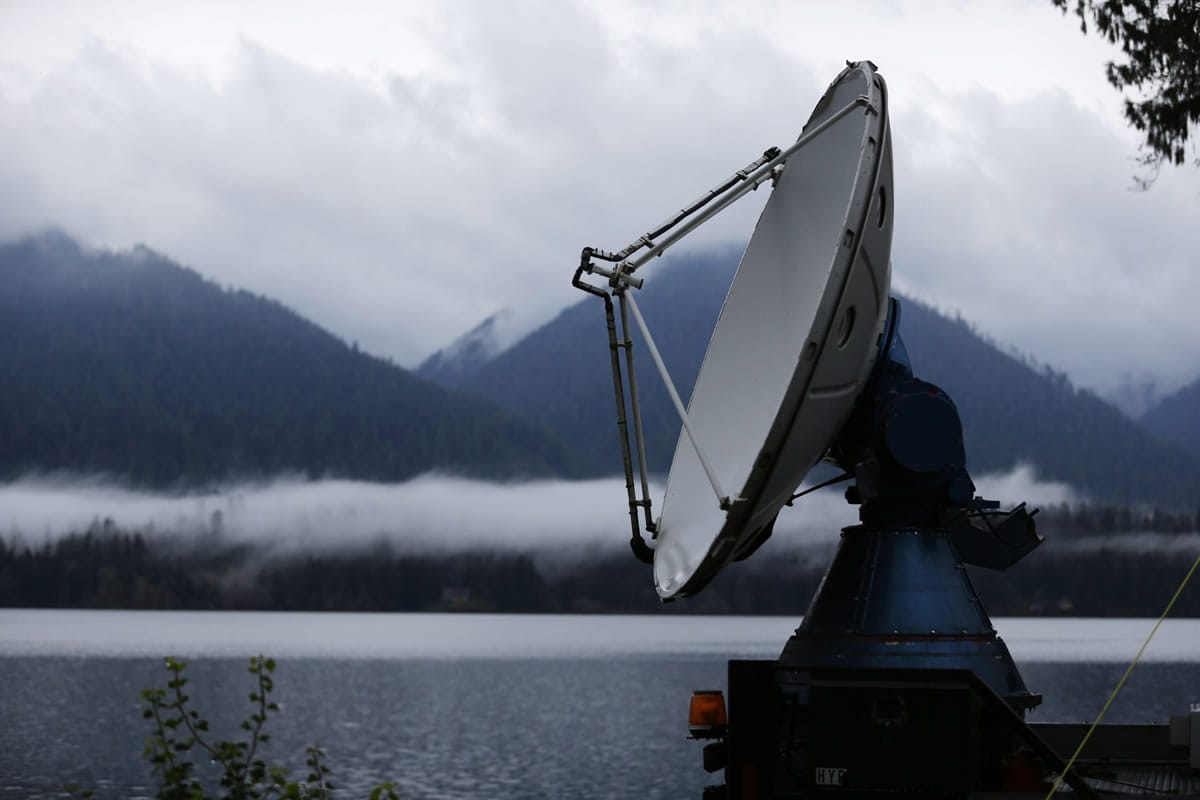 A truck-mounted radar instrument called the Doppler On Wheels scans cloudy skies Friday on the banks of Lake Quinault near Amanda Park. Led by NASA and hosted by the University of Washington, a team of meteorologists and scientists is fanning out across one of the wettest places in the country in November to measure raindrops and snowdrops and attempt to validate, on the ground, how well global satellites measure precipitation from space. (Ted S.