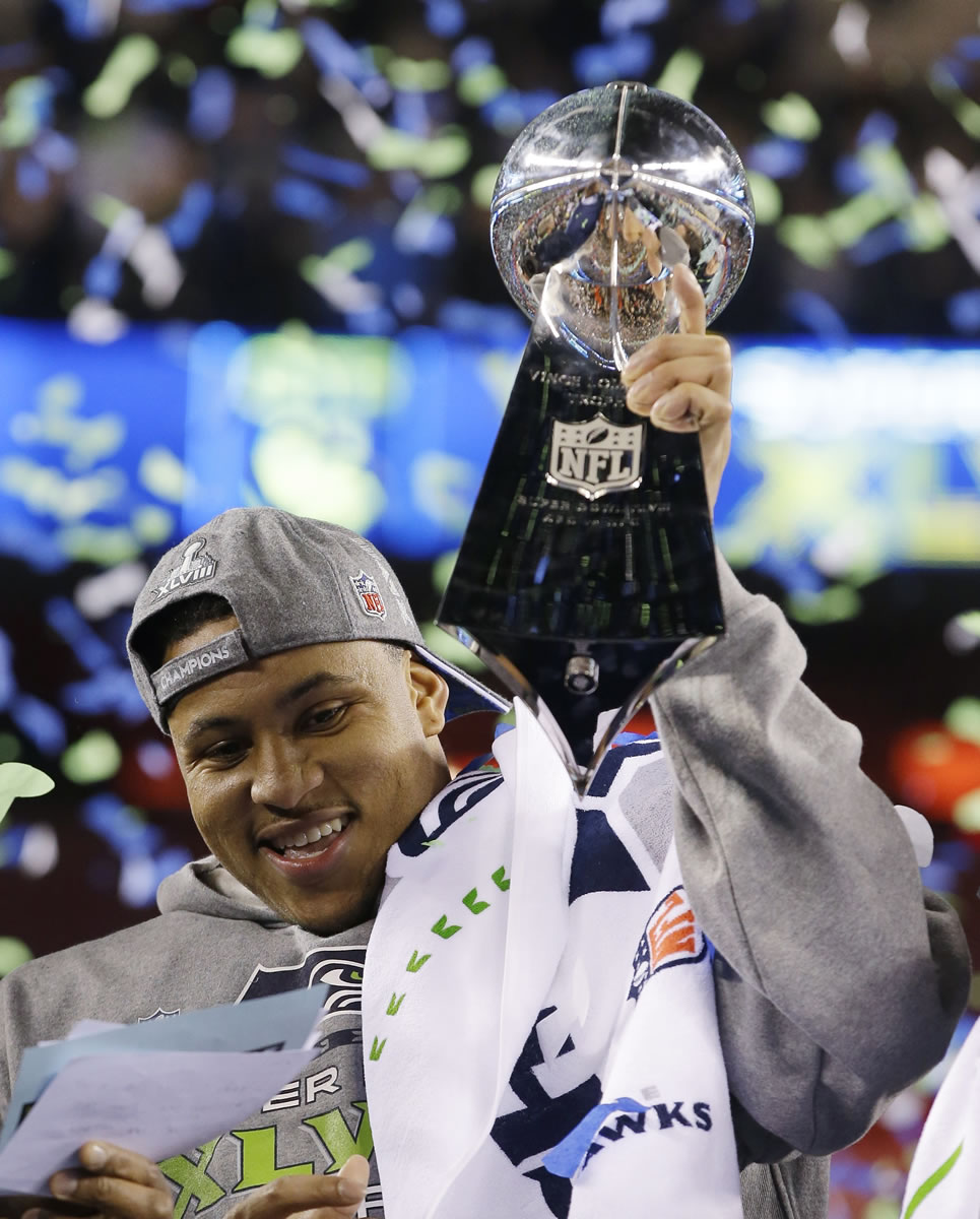 Seattle Seahawks' Malcolm Smith celebrates with the Vince Lombardi Trophy after the NFL Super Bowl XLVIII football game against the Denver Broncos Sunday, Feb. 2, 2014, in East Rutherford, N.J. The Seahawks won 43-8.