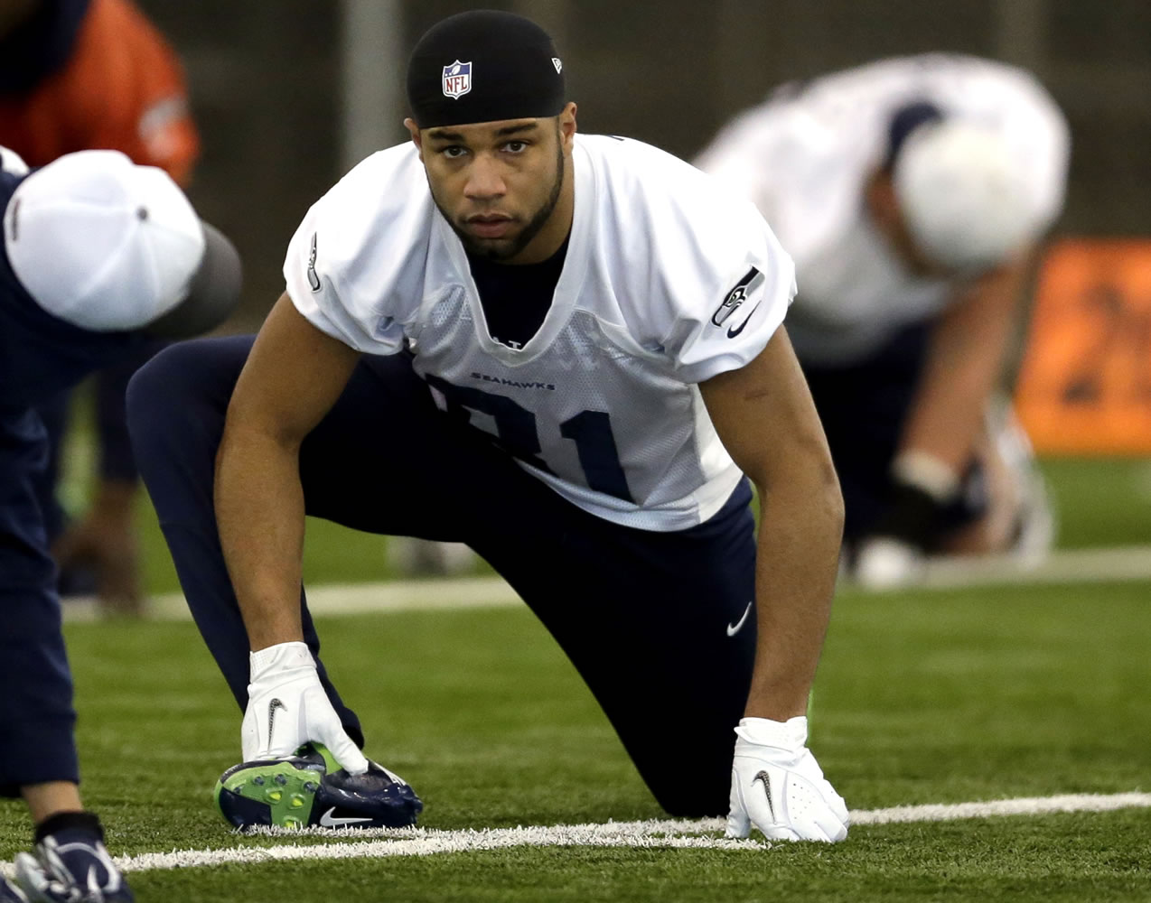 Wide receiver Golden Tate stretches during practice before the Super Bowl.