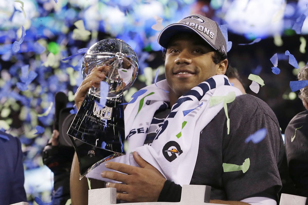 Seattle Seahawks' quarterback Russell Wilson holds the Lombardi Trophy after the NFL Super Bowl XLVIII football game Sunday, Feb. 2, 2014, in East Rutherford, N.J. The Seahawks won 43-8.