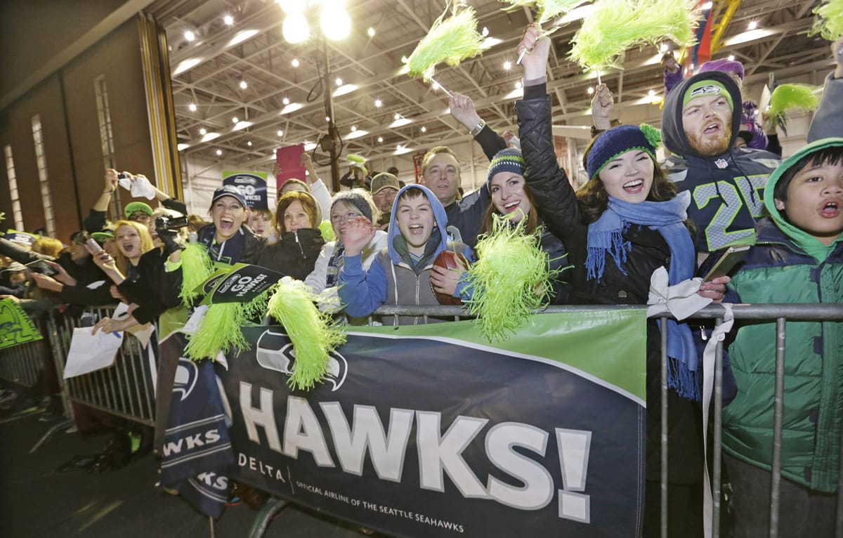 Fans greet Seattle Seahawks players and coaches during the team's arrival at Seattle-Tacoma International Airport on Monday after the team's Super Bowl victory.