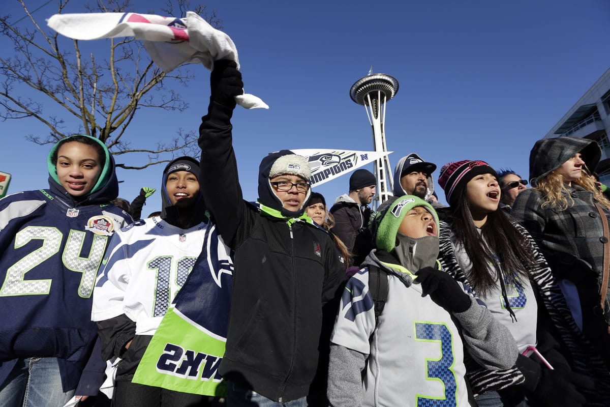 Seattle Seahawks fans cheer as they wait for the Seahawks' Super Bowl victory parade to begin Wednesday in Seattle.