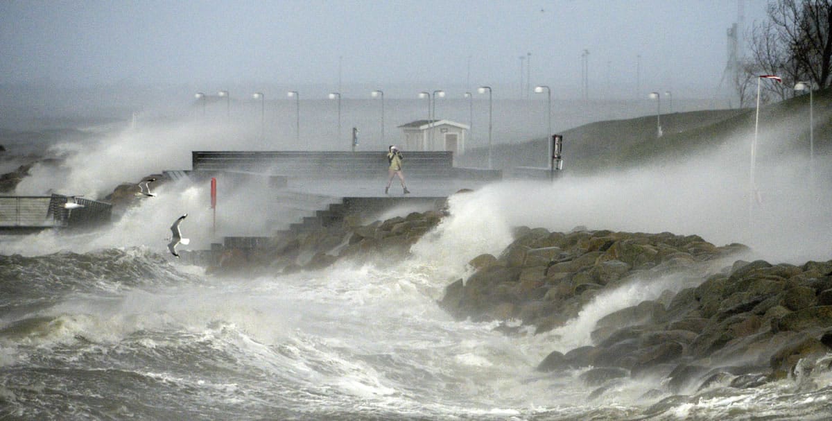 JOHAN NILSSON/Associated Press
A person faces the spray from crashing waves Friday in Malmo, Sweden.