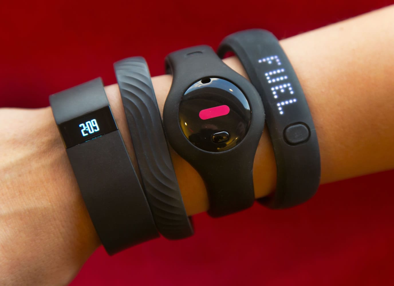 Four fitness trackers, from left: Fitbit Force, Jawbone Up, Fitbug Orb, and the Nike FuelBand SE.
