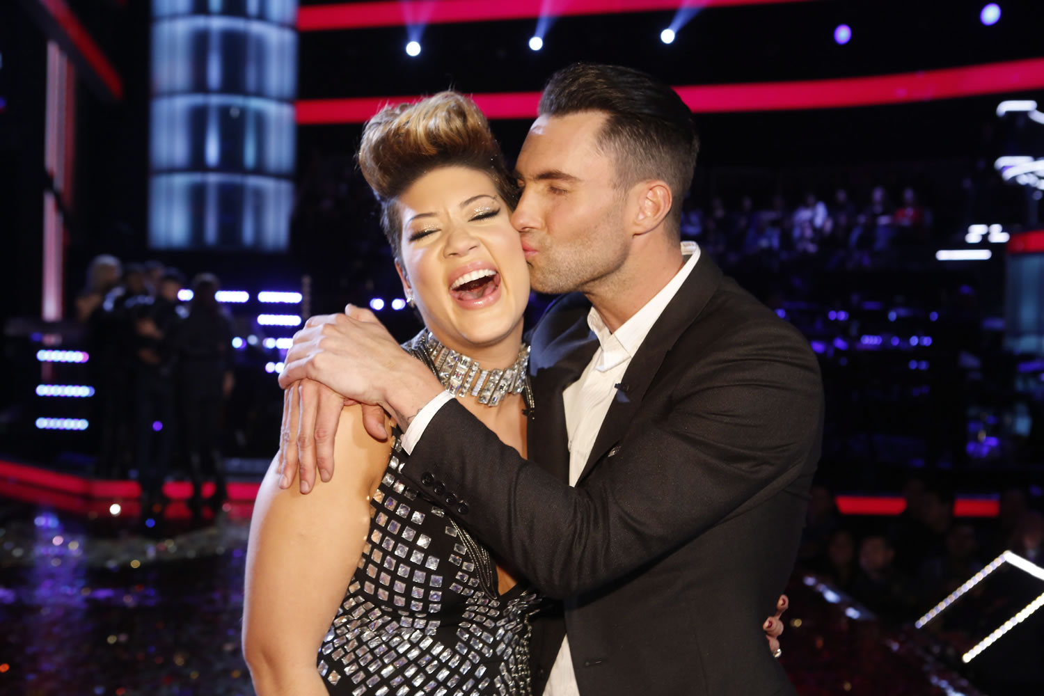 Maroon 5 frontman Adam Levine, right, kisses Tessanne Chin on the cheek after Chin was announced the season five winner of &quot;The Voice&quot; on Dec.