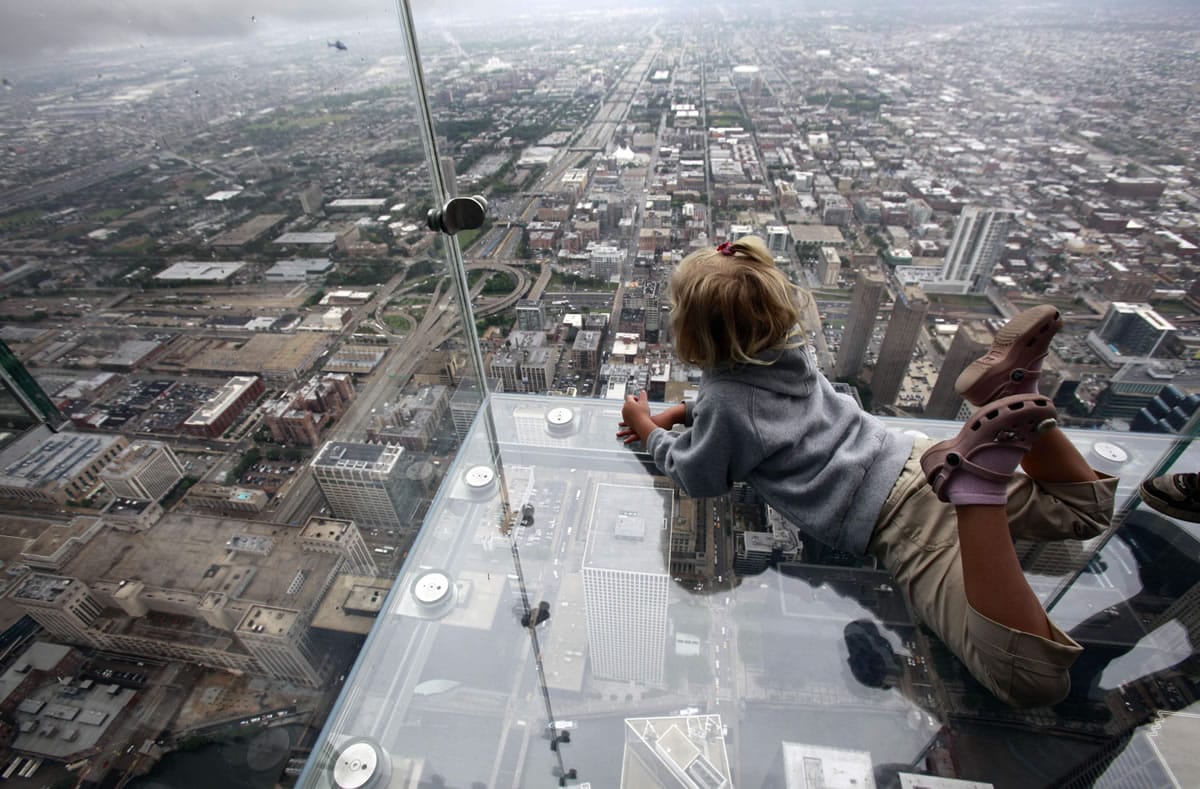 Anna Kane, 5, looks down from &quot;The Ledge,&quot; at Chicago's 110 story, 1,450-foot Willis Tower on June 24, 2009. The glass balcony is suspended 1,353 feet in the air and juts out four feet from the Sears Tower's 103rd floor Skydeck. The Tower is in contention with the 104-story, 1,776-foot One World Trade Center, a skyscraper built at the site of the 9/11 attacks on the World Trade Center in New York as the tallest building in America.