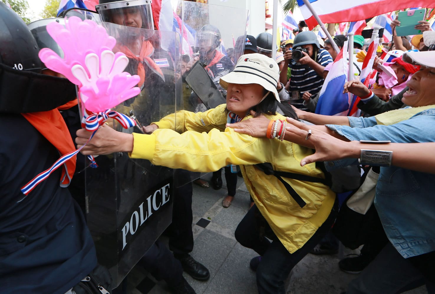 Thai anti-government protesters, right, push through line of riot police during a rally at the Department of Special Investigation on the outskirts of Bangkok, Thailand, on  Monday.