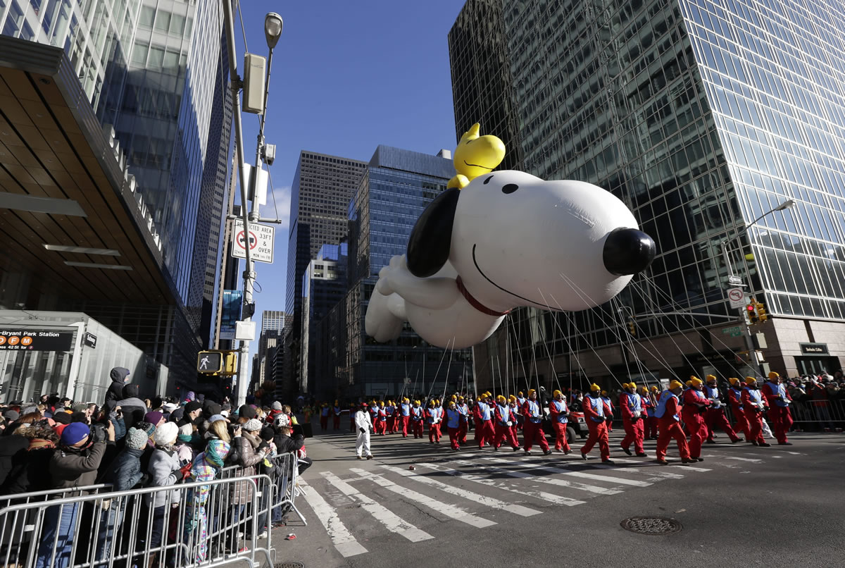 Snoopy flies by as spectators look on during the Macy's Thanksgiving Day Parade on Thursday in New York.