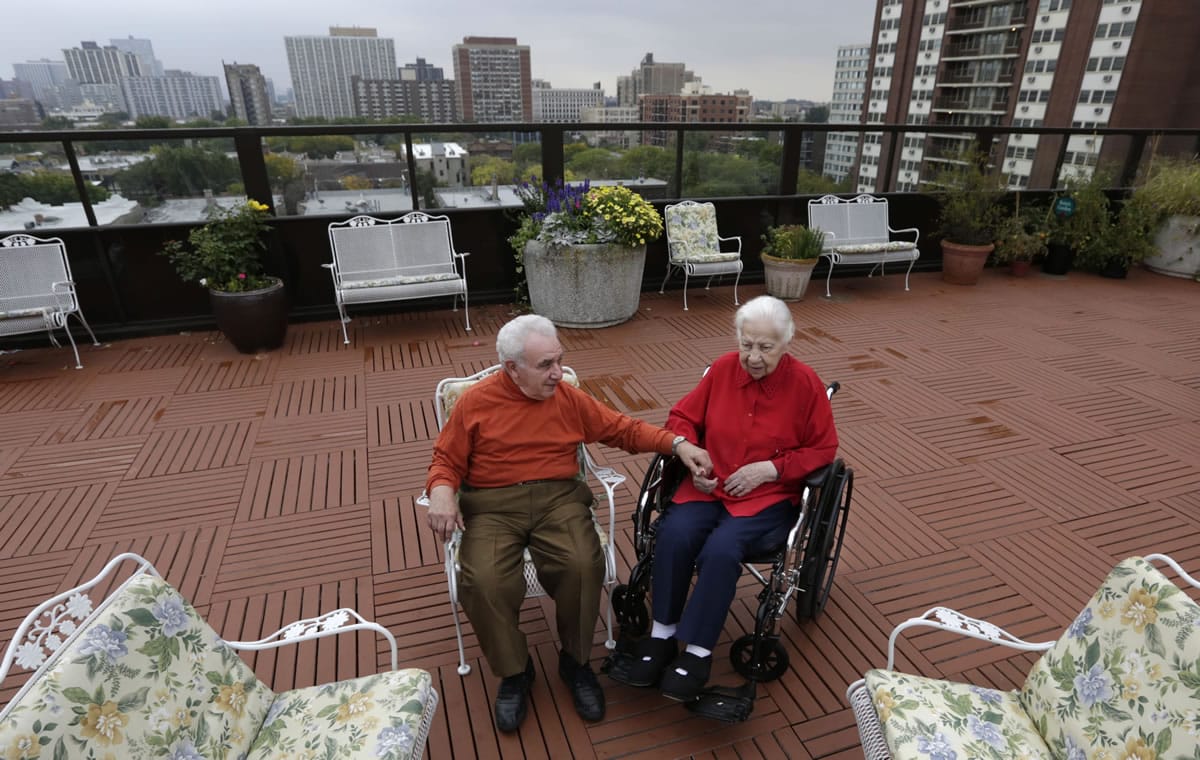 Joe Chaba and his wife, Helen, 89, sit together on the rooftop at The Selfhelp Home.
