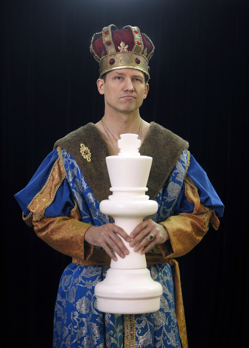 Michael Fisher, of Pittsford, N.Y., holds an oversized chess piece.