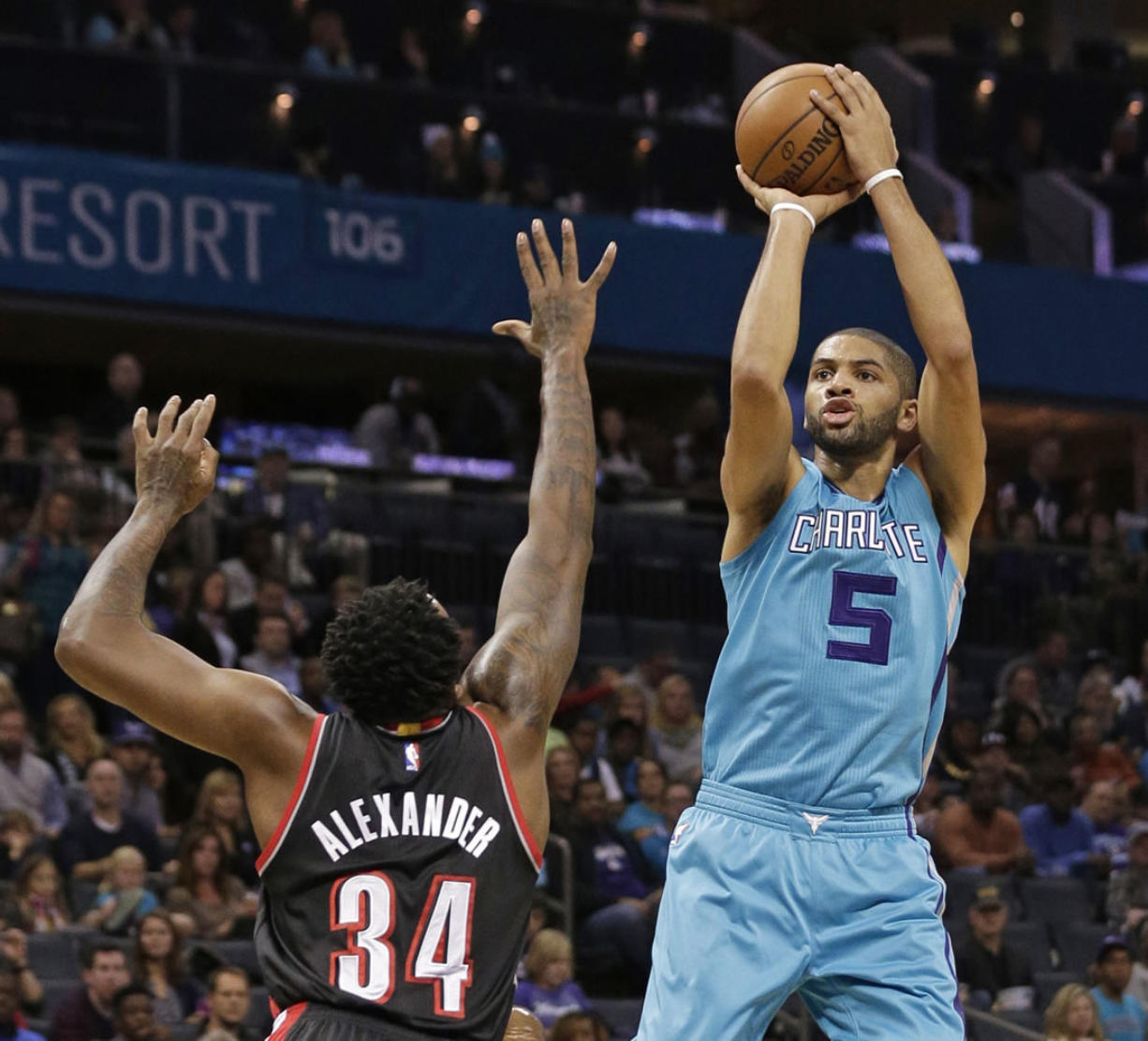 Charlotte Hornets' Nicolas Batum shoots over Portland Trail Blazers' Cliff Alexander during the first half of an NBA basketball game in Charlotte, N.C., Sunday, Nov. 15, 2015.