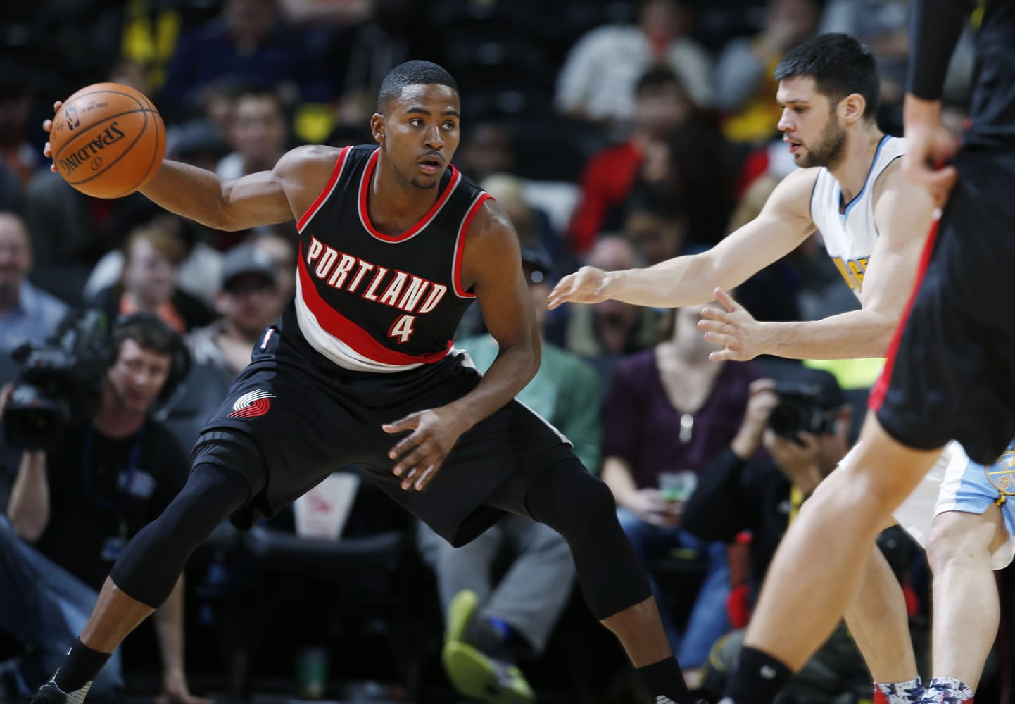 Portland Trail Blazers forward Maurice Harkless, left, pulls in the ball as Denver Nuggets forward Kostas Papanikolaou defends in the second half of an NBA basketball game Monday, Nov. 9, 2015, in Denver. The Nuggets won 108-104.