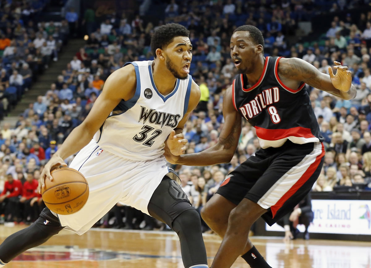 Minnesota Timberwolves? Karl-Anthony Towns, left, drives around Portland Trail Blazers? Al-Farouq Aminu in the first half of an NBA basketball game, Monday, Nov. 2, 2015, in Minneapolis.