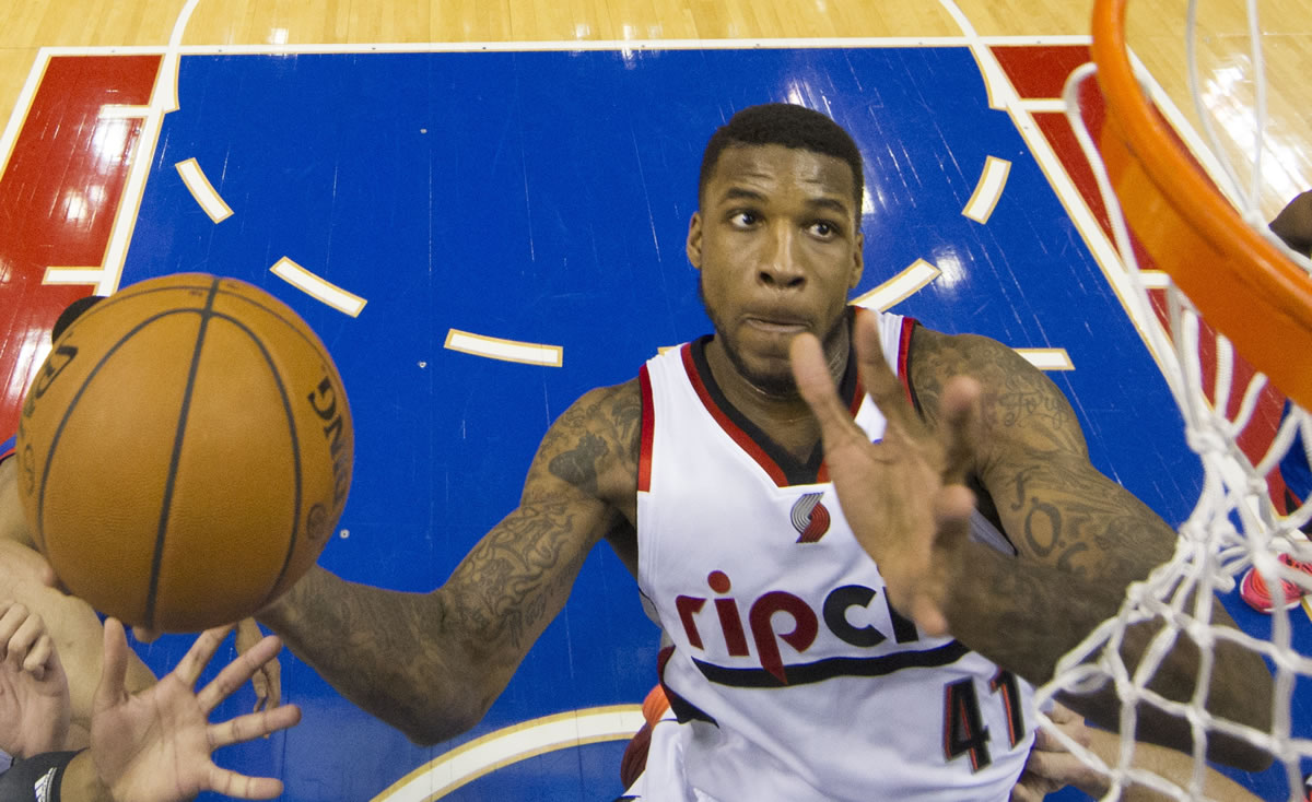 Portland Trail Blazers' Thomas Robinson goes up to shoot during the first half of an NBA basketball game against the Philadelphia 76ers, Saturday, Dec. 14, 2013, in Philadelphia.