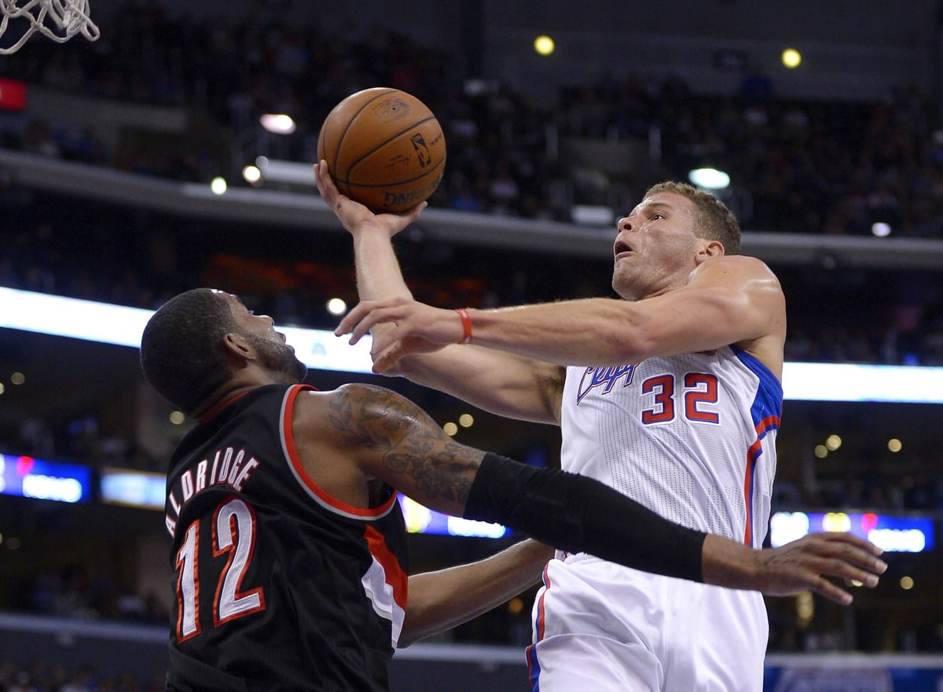 Los Angeles Clippers forward Blake Griffin, right, puts up a shot as Portland Trail Blazers forward LaMarcus Aldridge defends during the first half of an NBA basketball game, Wednesday, Feb. 12, 2014, in Los Angeles. (AP Photo/Mark J.