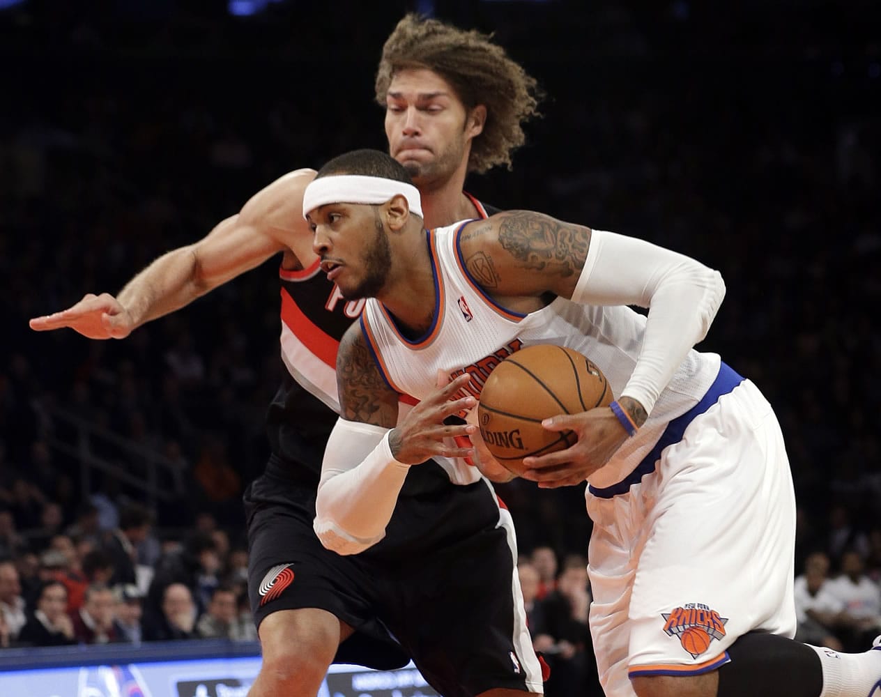 New York Knicks' Carmelo Anthony (7) drives past Portland Trail Blazers' Robin Lopez (42) during the first half of an NBA basketball game, Wednesday, Feb. 5, 2014, in New York.