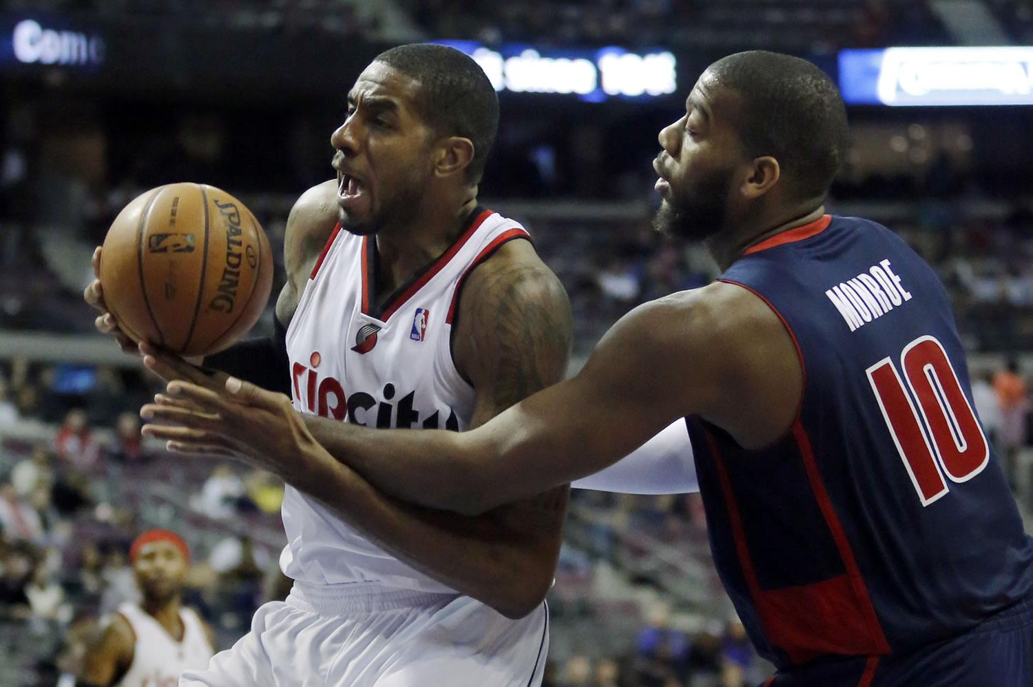 Portland Trail Blazers forward LaMarcus Aldridge, left, is fouled by Detroit Pistons center Greg Monroe (10) while going to the basket during the second half Sunday.