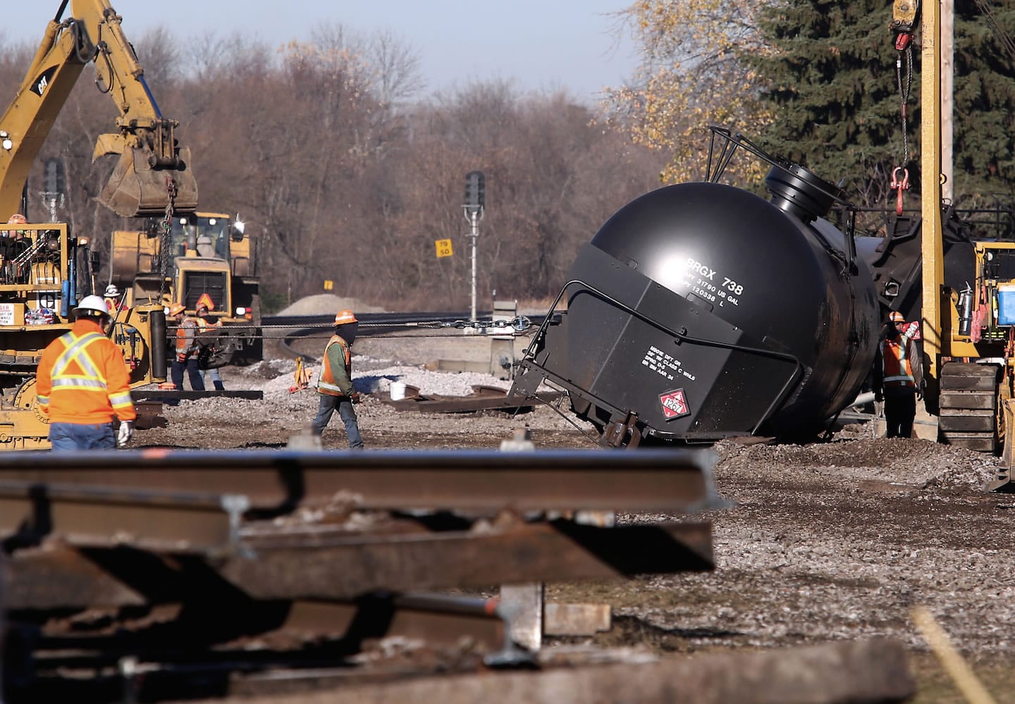 Workers tend to the scene of a train derailment in Watertown, Wis. Monday after a 13 cars of a Canadian Pacific train carrying crude oil overturned Sunday. One of the cars was punctured, spilling less than 1,000 gallons of oil. Thirteen of 110 cars derailed in Watertown Sunday afternoon, the second derailment in Wisconsin in as many days.