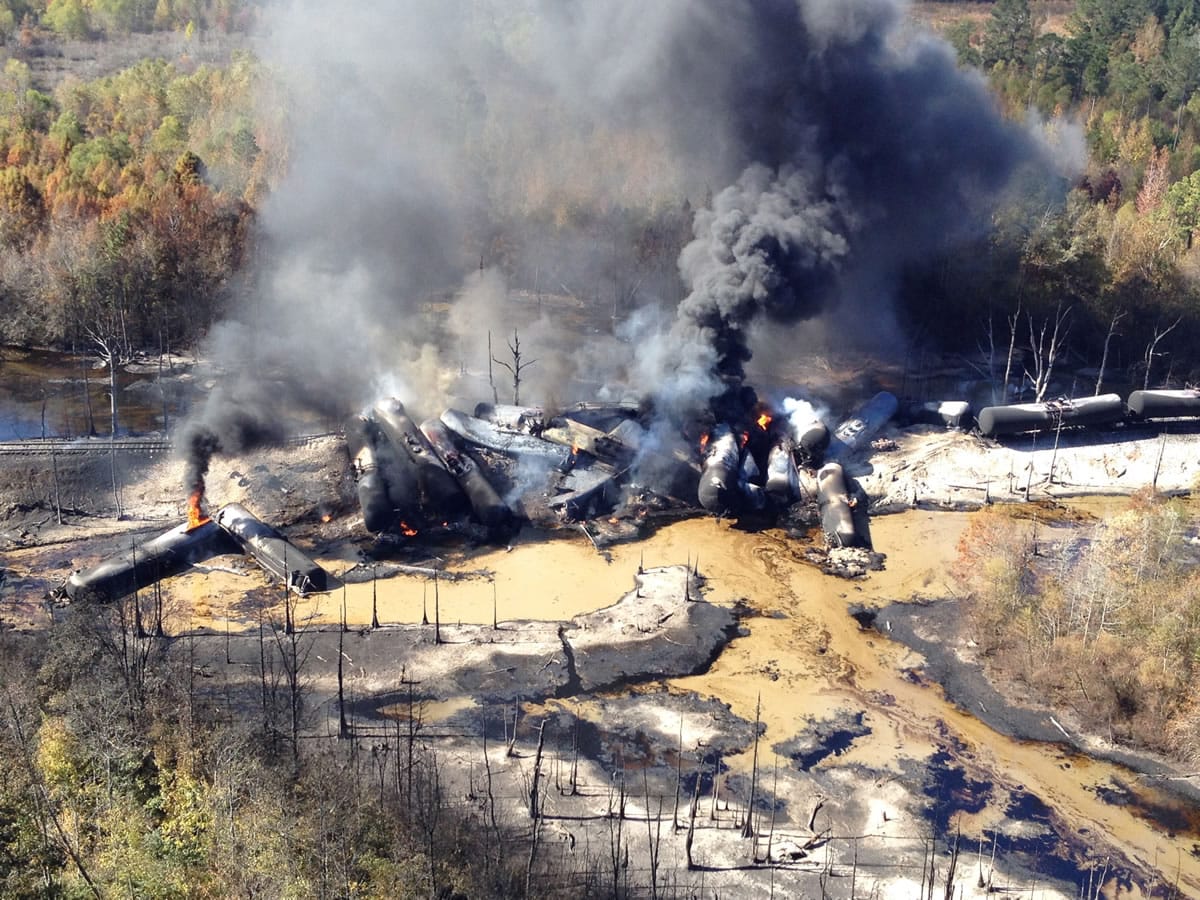 A tanker train carrying crude oil burns after derailing in western Alabama outside Aliceville early Friday.
