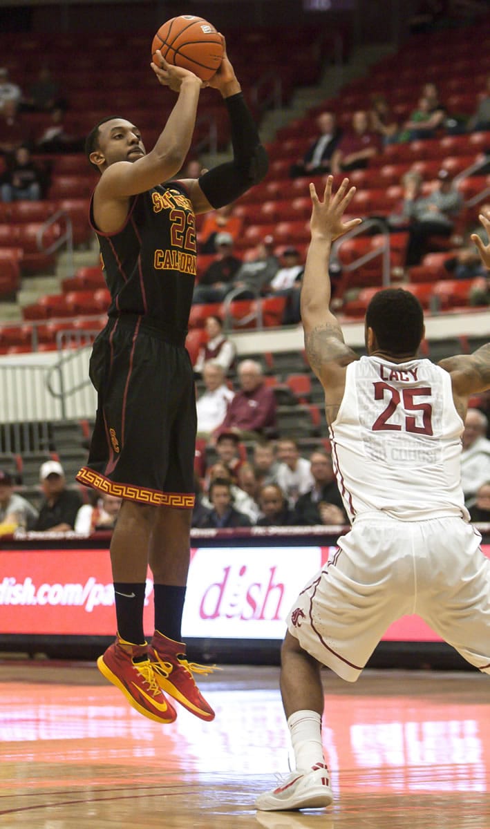 Southern California guard Byron Wesley (22) scores on this 3-point shot over Washington State guard DaVonte Lacy (25) during the first half of an NCAA college basketball game Thursday, March 6, 2014, at Beasley Coliseum in Pullman, Wash.