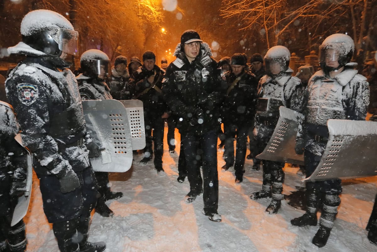 Vitali Klitschko, chairman of the Ukrainian opposition party Udar and boxing champion, is surrounded by riot police trying to prevent clashes Monday in Kiev.