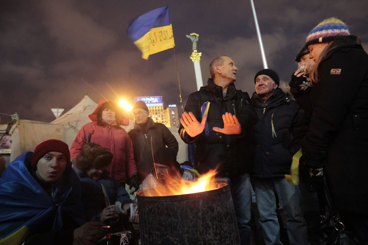 Protesters warm themselves around a fire in Independence Square on Saturday in Kiev, Ukraine.