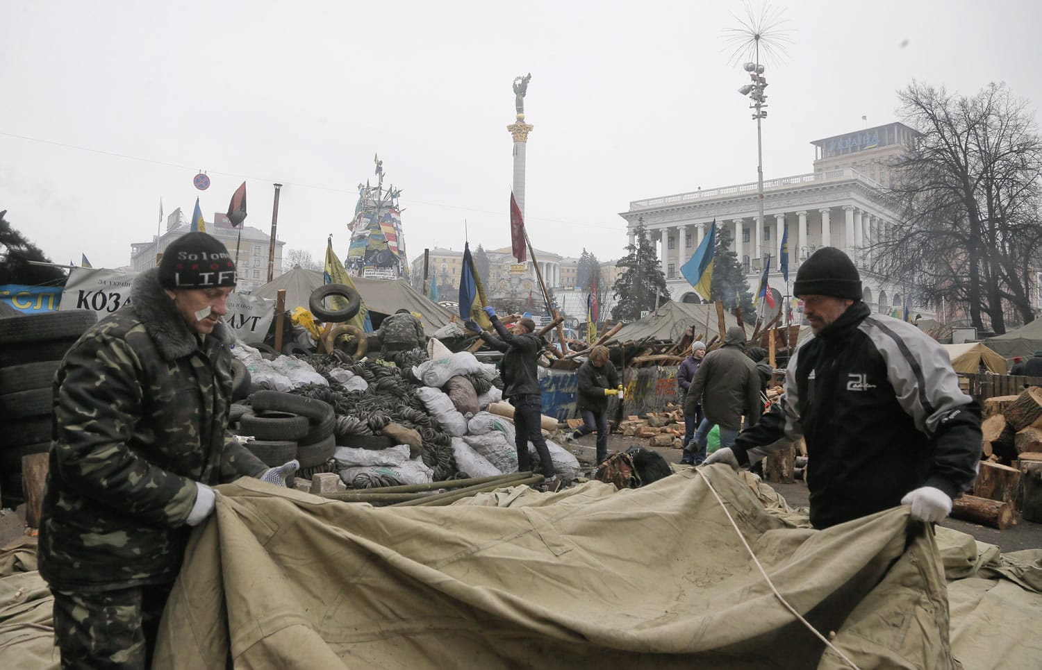 Volunteers remove barricades after recent deadly clashes with riot police in the center of Kiev, Ukraine, on Saturday.