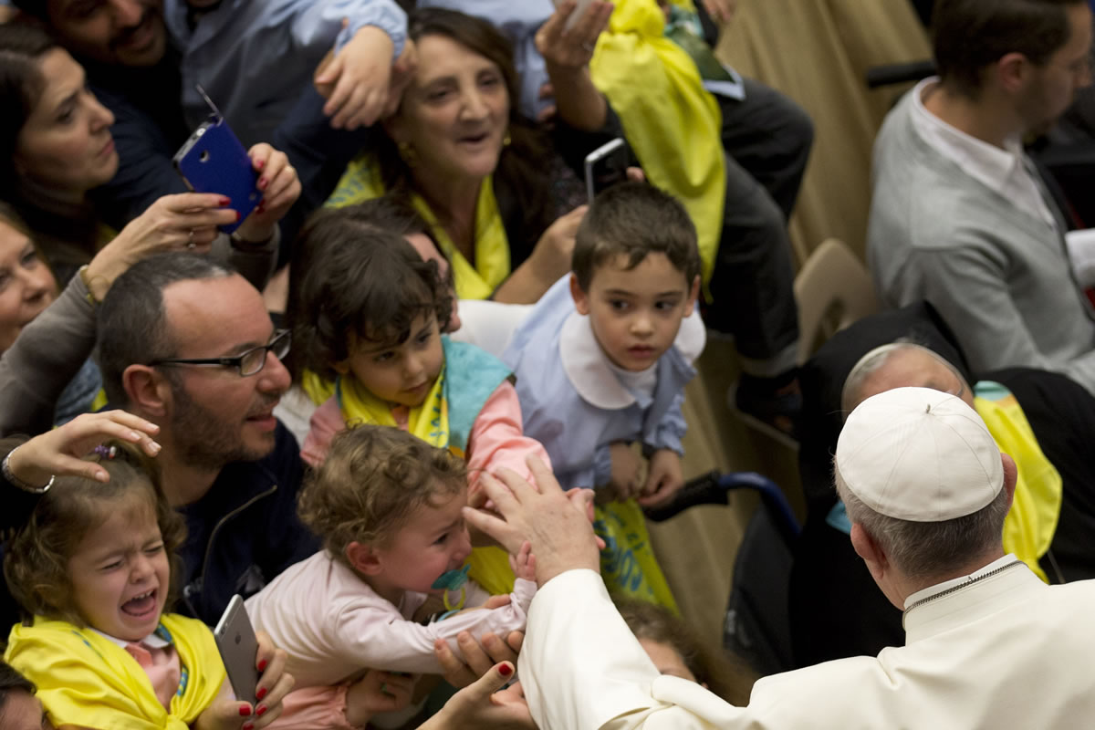 Pope Francis greets children Nov. 12 in the Pope Paul VI hall, at the Vatican. Pope Francis is writing a children&#039;s book.