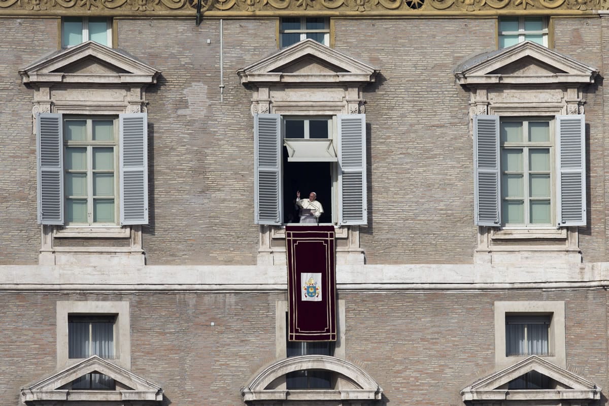 Pope Francis delivers his blessing during the Angelus noon prayer he celebrated from the window of his studio overlooking St. Peter's Square at the Vatican on Wednesday. &quot;We are all children of one heavenly father, we belong to the same human family and we share a common destiny,&quot; Francis said, as tens of thousands of faithful, tourists and Romans jammed St.