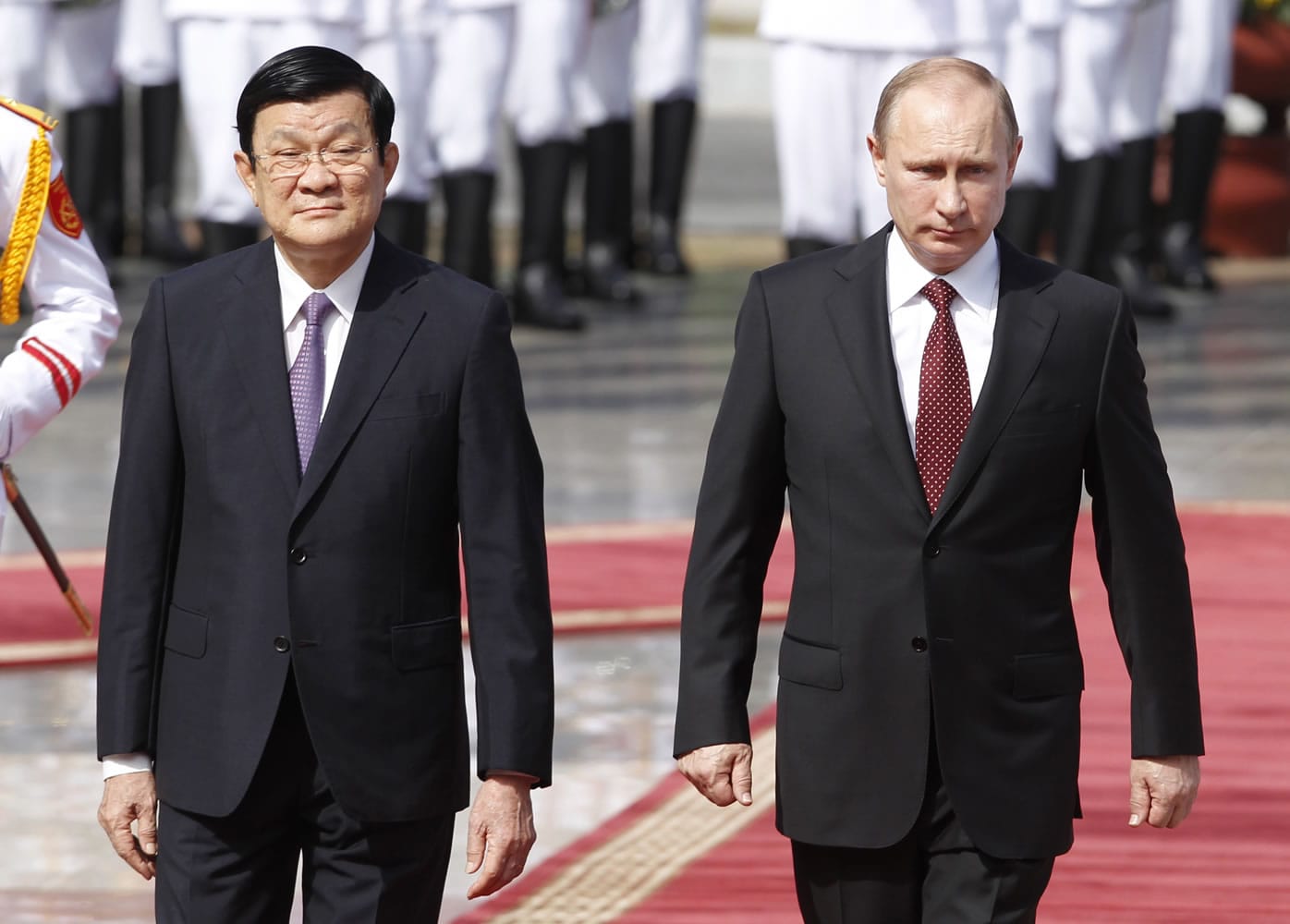 Russian President Vladimir Putin, right, and his Vietnamese counterpart, Truong Tan Sang, walk together as they review the guard of honor during a welcoming ceremony at the Presidential Palace in Hanoi on Tuesday.