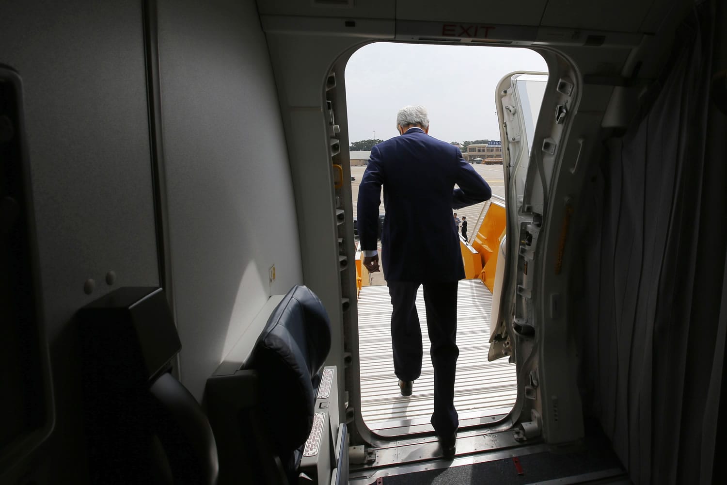 U.S. Secretary of State John Kerry gets off his plane Saturday at the airport in Ho Chi Minh City, Vietnam.