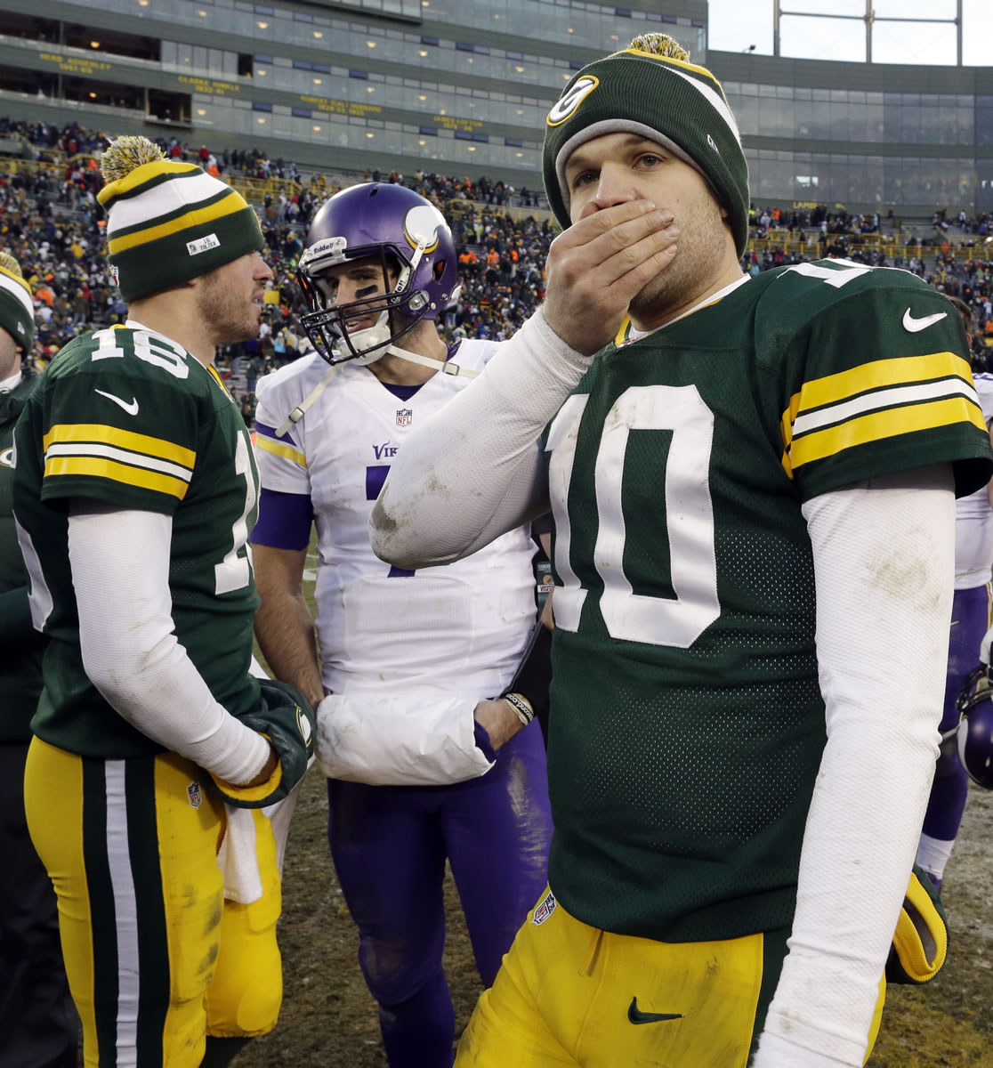 Green Bay Packers' Matt Flynn (10) covers his face as Scott Tolzien (16) talks to Minnesota Vikings' Christian Ponder after an NFL football game Sunday, Nov. 24, 2013, in Green Bay, Wis. The game ended in a tie, 26-26.