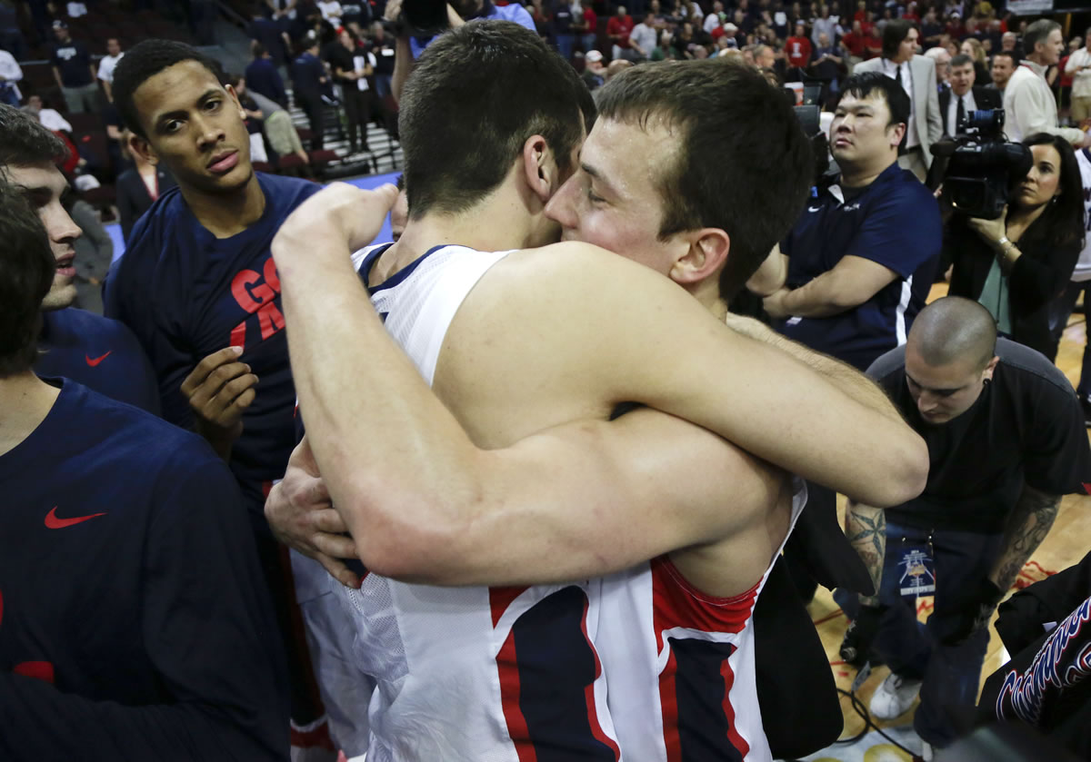 Gonzaga's Kevin Pangos, right, hugs Drew Barham after Gonzaga defeated BYU in the WCC title game.