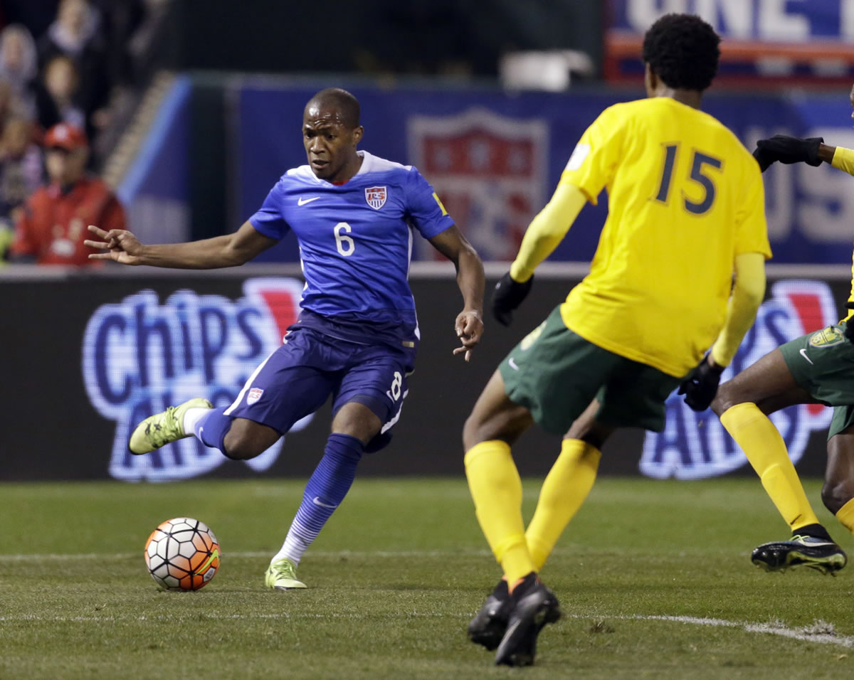 Darlington Nagbe, left, controls the ball as St. Vincent and the Grenadines Kevin Francis (15) defends during the second half of a 2018 World Cup qualifying soccer match Friday, Nov. 13, 2015, in St. Louis. The United States won 6-1.