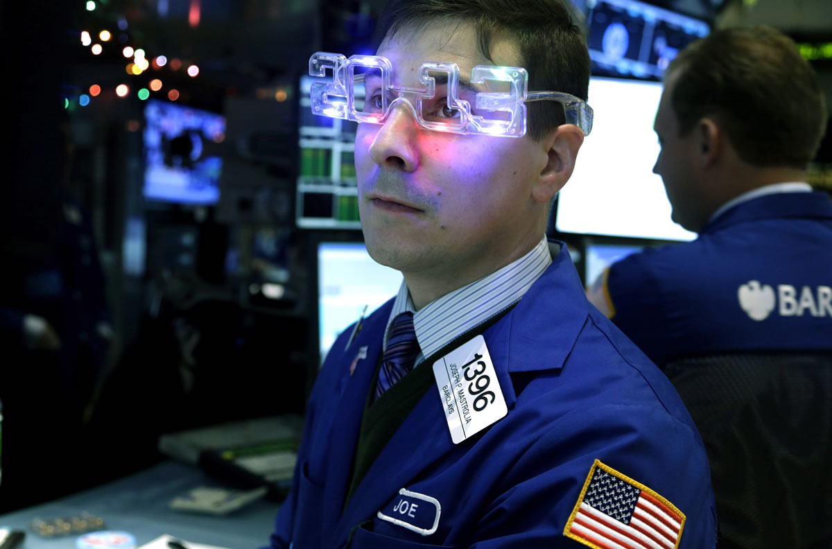 A trader wearing &quot;2013&quot; glasses works on the floor at the New York Stock Exchange in New York on Dec. 31.