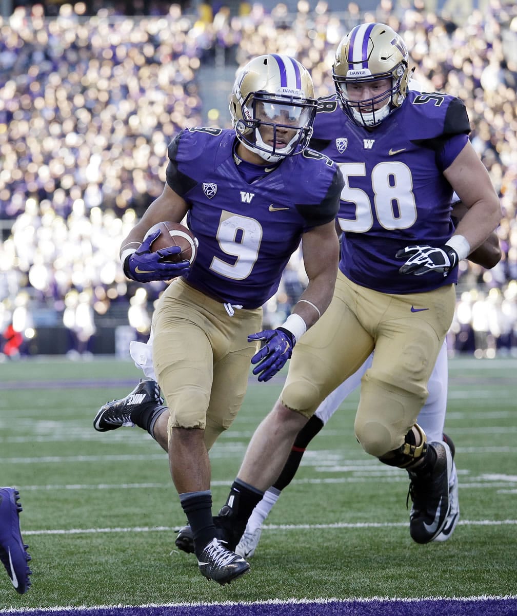 Washington&#039;s Myles Gaskin (9) scores against Washington State as Kaleb McGary follows in the first half of an NCAA college football game Friday, Nov. 27, 2015, in Seattle.