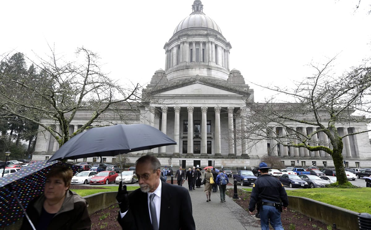 A sidewalk outside the Legislative building is bustling with people on the first day of the 2014 session of the Washington Legislature on Jan. 13 in Olympia.