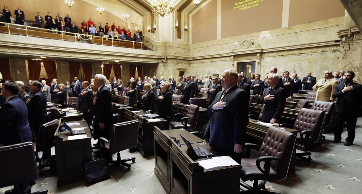 Members of the House recite the pledge of allegiance Monday on the first day of the 2014 session of the Washington state Legislature at the Capitol in Olympia.