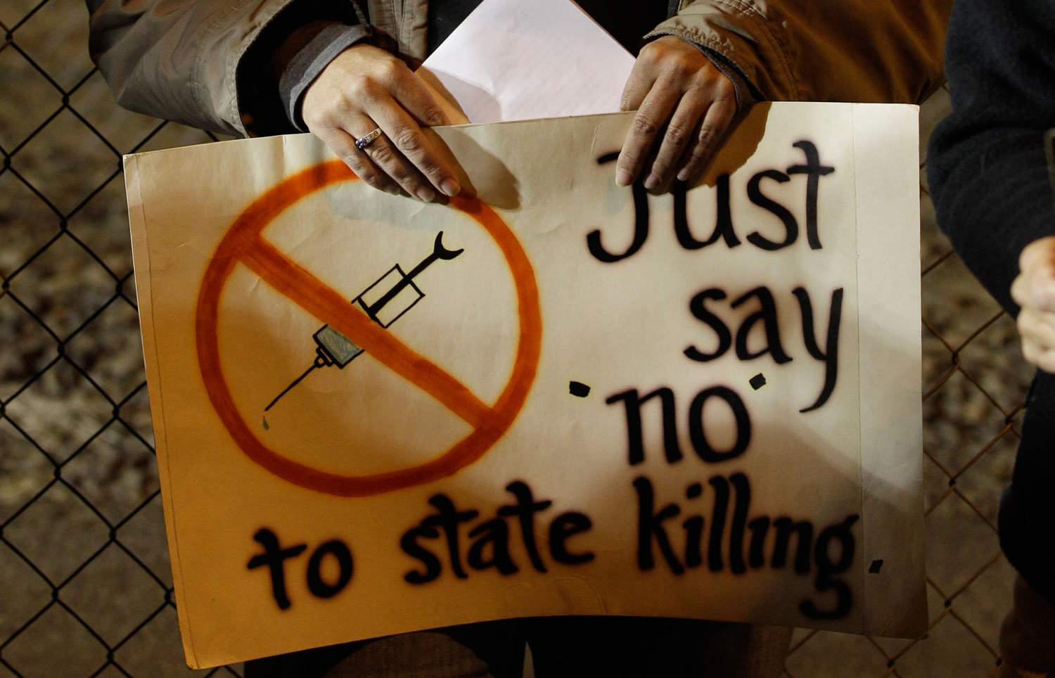 Shar Lichty holds a sign in 2010 that reads &quot;Just say 'no' to state killing,&quot; as she stands during a gathering of protestors outside the Washington State Penitentiary, in Walla Walla, during the execution of Cal Coburn Brown for a 1991 murder. Gov.