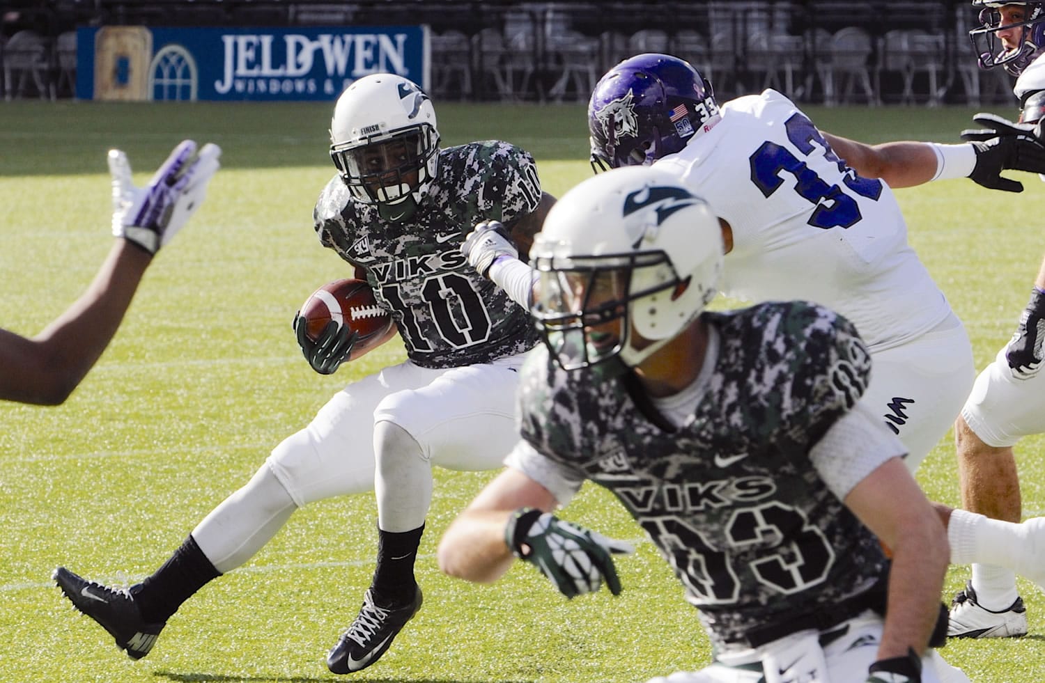 Weber State's Karl Finai (33) defends against Portland State's DJ Adams (10) during the first half of an NCAA college football game in Portland, Ore., Saturday Nov 2, 2013.