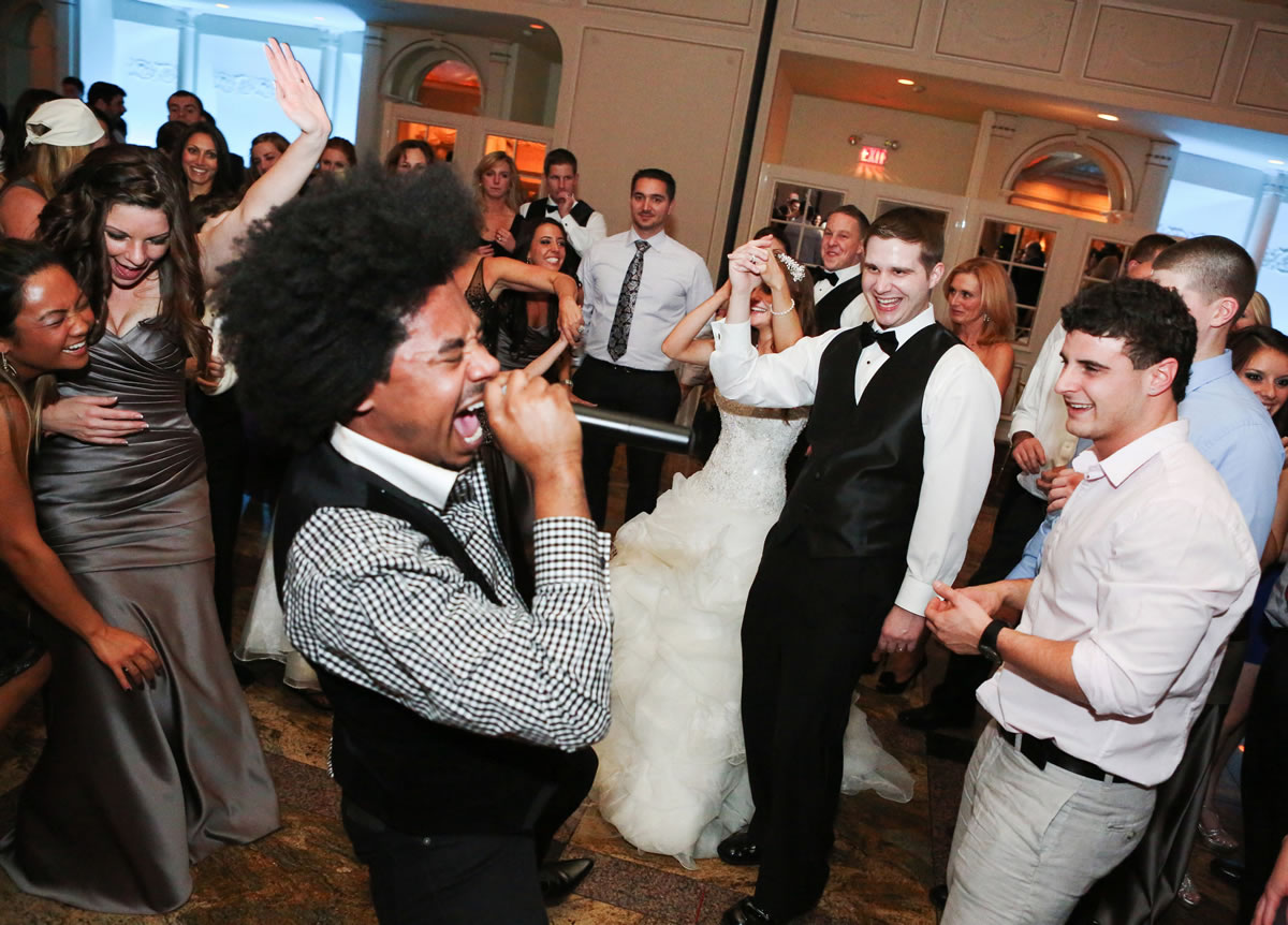 Groom Jim Mallon, second right, enjoys singer Gedeon McKinney and the Uptown Swing Band he hired for his wedding to his bride, Alana Mallon, in New Rochelle, N.Y.