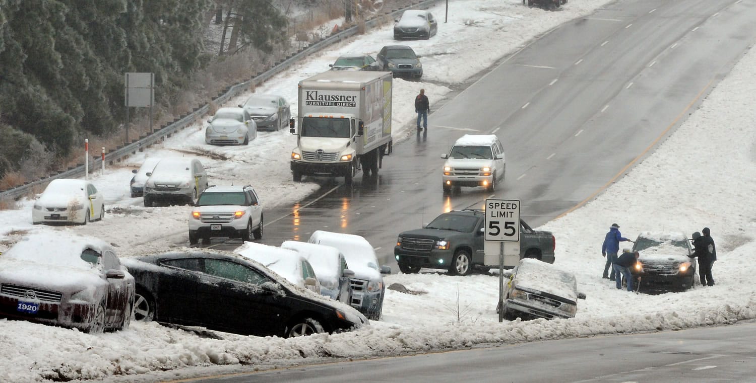 Wrecked and abandoned vehicles litter Hwy 70 near the Angus Barn in Raleigh, N.C., on Thursday.