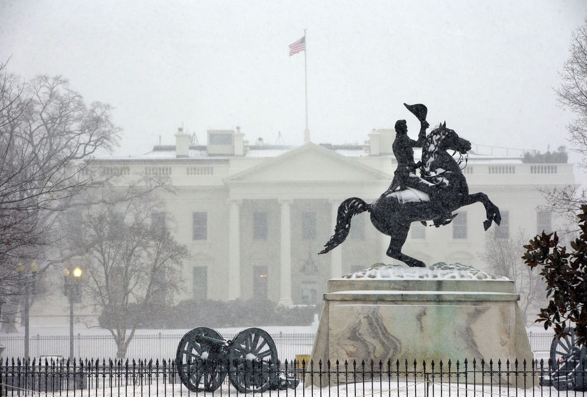 The statue of President Andrew Jackson at the Battle of New Orleans, sculpted in 1853 by Clark Mill sits in the falling snow in Lafayette Park across the street from the White House in Washington, on Monday.